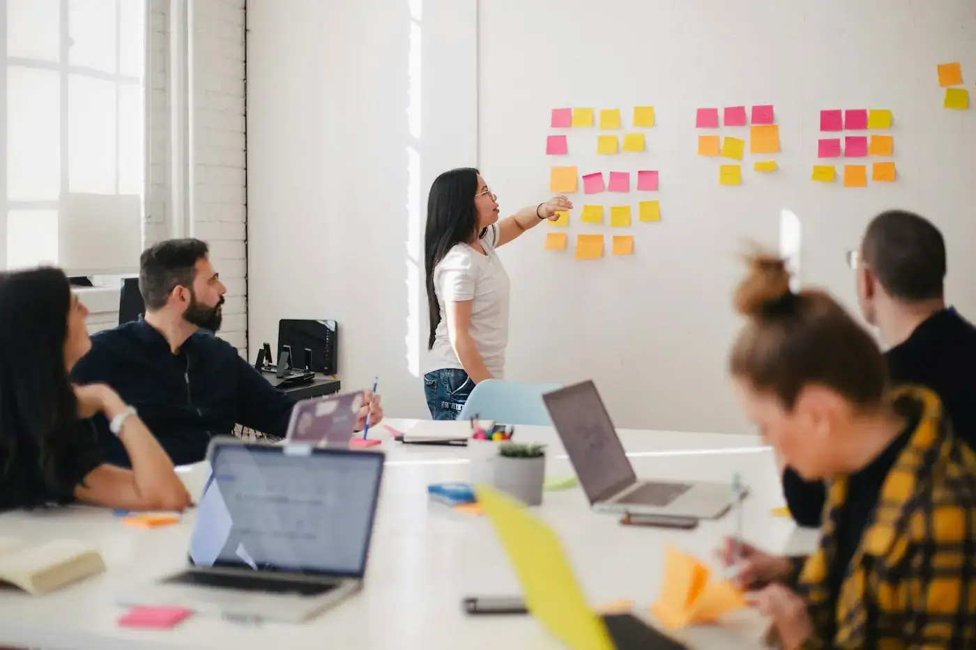 A team planning with sticky notes on a wall