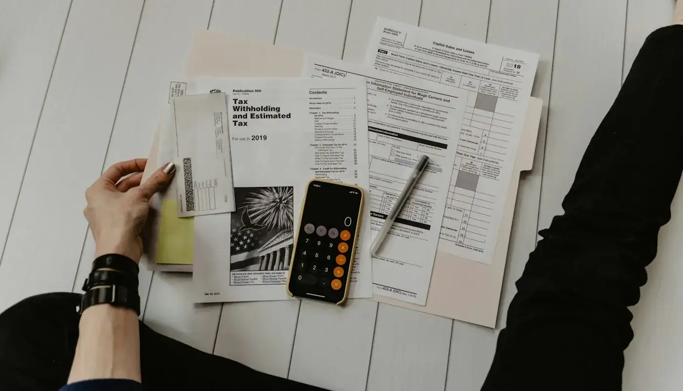 Financial paperwork with a calculator and pen